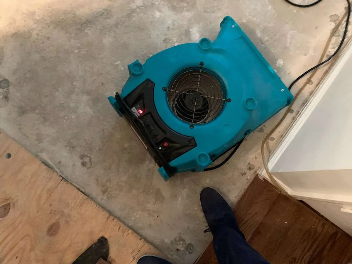 Air mover drying subfloor during Commercial Water Damage Restoration in Austell
